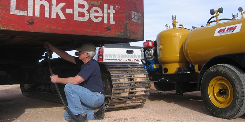 Sage Oil Vac Jobsite Spills Man Changing Oil on Heavy Machinery